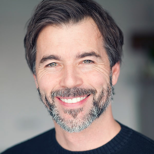 Middle-aged man happily smiling