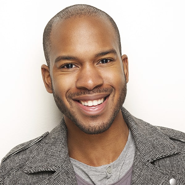 Middle-aged man is happily smiling on a studio background