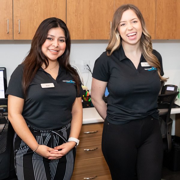 New Patients are greeted by two members of Las Vegas Blvd Dental happily smiling