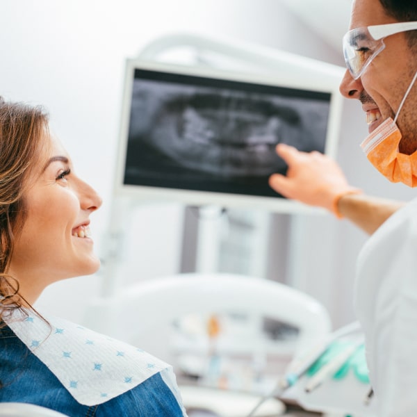 A young woman at the dentist's office waiting for her dental exam while smiling