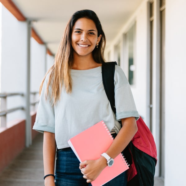 Girl with a backpack is smiling after getting Deep Cleanings at the dentist
