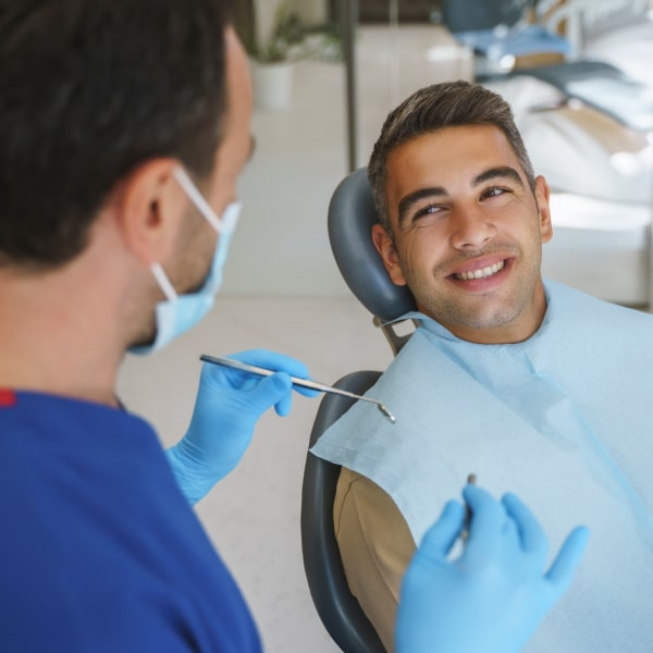 Middle-aged man happily smiling with before procedure