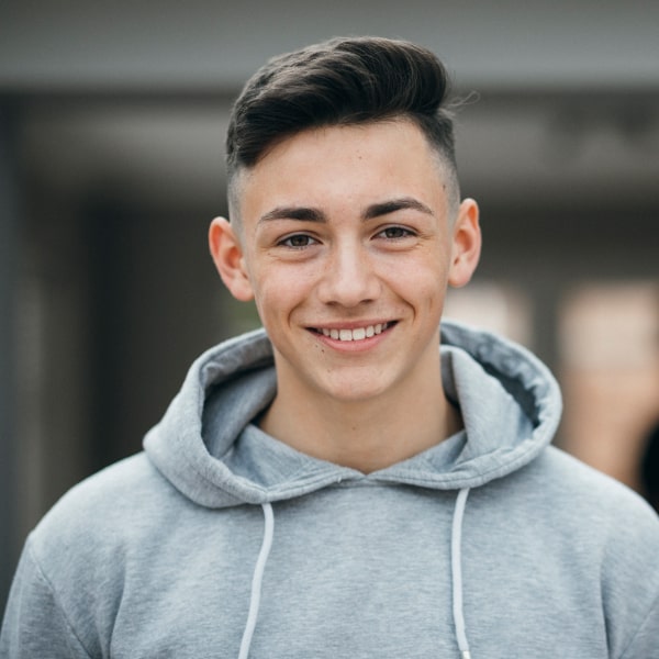 A young boy is happily smiling after Wisdom Tooth Extractions