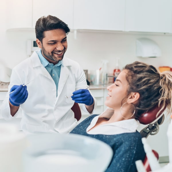 The doctor smiles while preparing the patient for the procedure