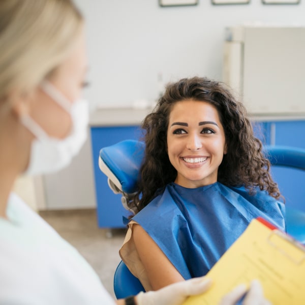 Woman is happily smiling in the dental chair